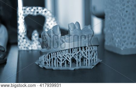 White Prototype Of The Human Foot Skeleton Printed On 3d Printer On Dark Surface