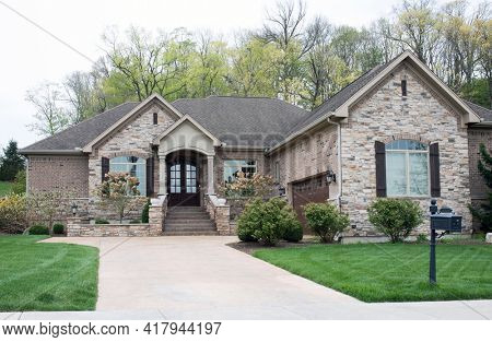Luxurious Beige Stone and Brick Home In Springtime