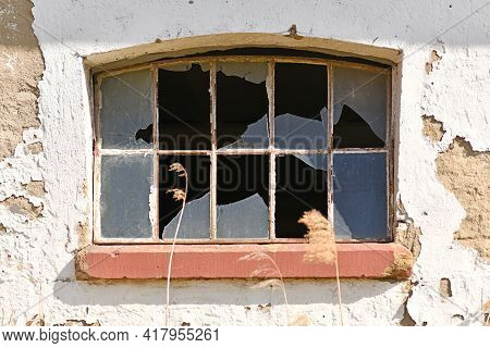 Muntin Window With Broken Glass Of Old Abandoned Building