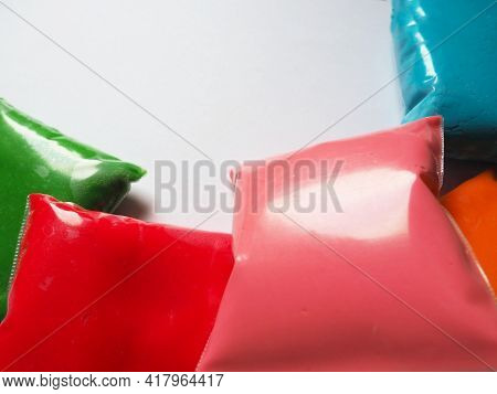 Colorful Kid's Plasticine On White Background, Colorful Dough Modeling Clay. Packing Of Colored Soft