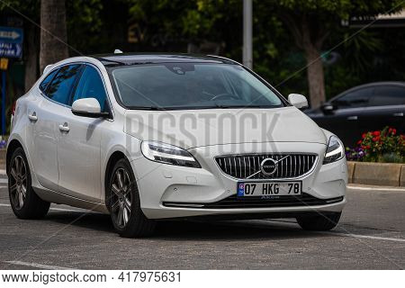 Alanya, Turkey  - April 12 2021:  White Volovo V40 Is Driving Fast On The Street On A Warm Summer Da