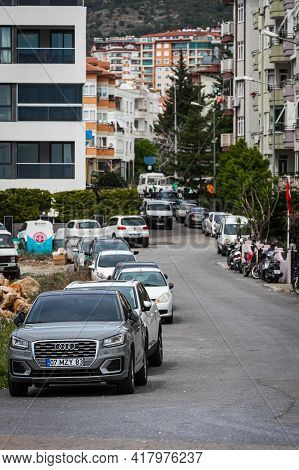 Alanya, Turkey - April 10 2021:  City Street With Multi-storey Houses Of The Same Type, Parked Cars,