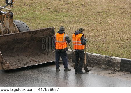 Its A Clean City. People, Workers Clean The Roads. Roadworks And Road Cleaning. High Quality Photo