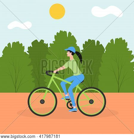 Young Sports Girl Rides A Bicycle In The City Park. The Concept Of Outdoor Activities In The City. C