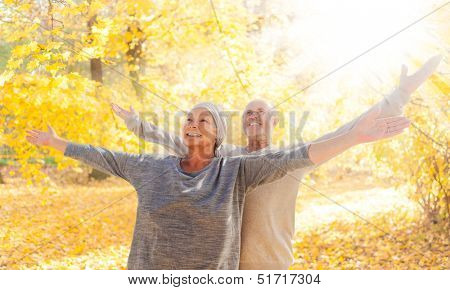 autumn couple  with outstreched arms