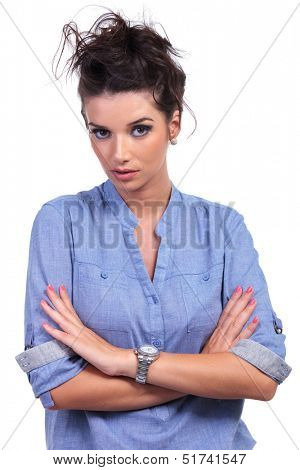 closeup of a young casual woman posing with her hands crossed and looking into the camera. on white background