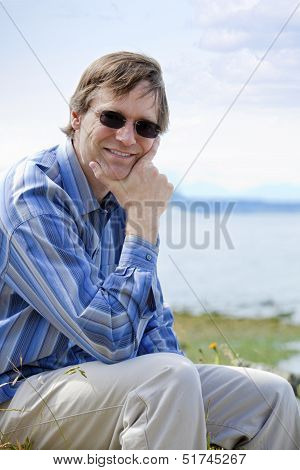 Handsome Causcasian Man In Forties Relaxing By Lake Side
