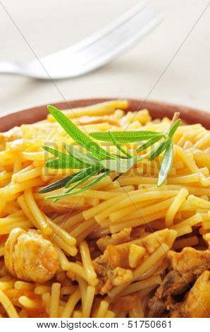 closeup of an earthenware bowl with spanish noodles with chicken
