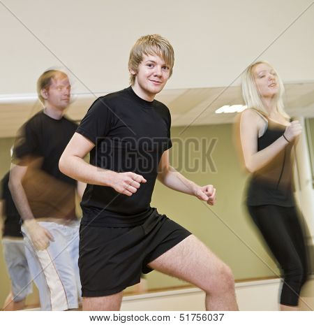 Group of people doing step up with a boy in focus