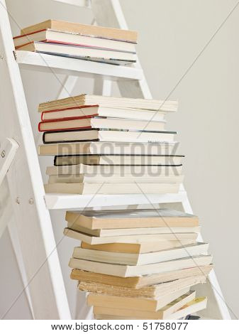 Pile of books on a ladder