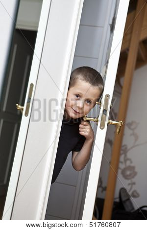 Little Boy looking out from the Closet