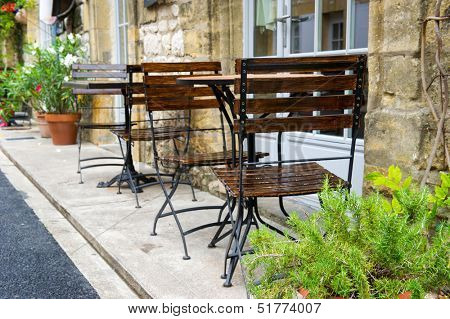 empty French terrace with tables and chairs