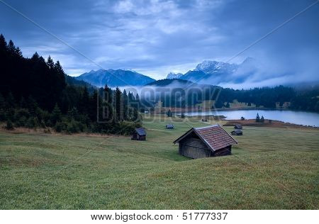 Wooden Hut And Morning Fog Over Geroldsee Lake