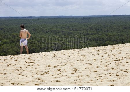 PYLA SUR MER, FRANCE - AUGUST 8: Man visits the Famous dune of Pyla, the highest sand dune in Europe, on August 8, 2012 in Pyla Sur Mer, France.
