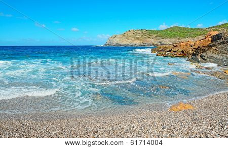 Blue Water And Pebbles In Argentiera