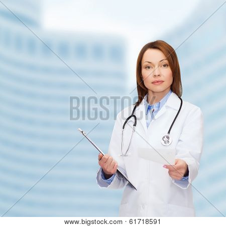 healthcare and medicine concept - calm female doctor with clipboard and stethoscope