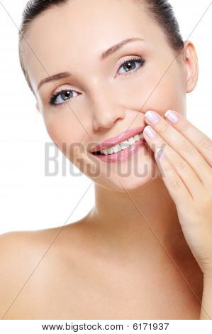 Pretty Smiling Young Woman With Hand At Lips