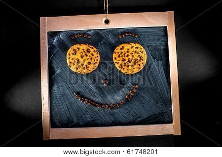 Word Coffee Written With Coffee Beans And Oatcake On Chalkboard