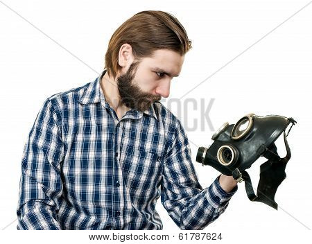 the man with beard watching at a gas mask