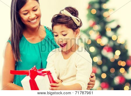 holidays, presents, christmas, x-mas concept - happy mother and child girl with gift box