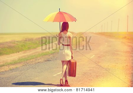 Redhead Enchantress Walking Near Rapeseed Field. Photo In Old Image Style.