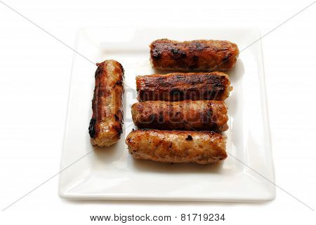 Cooked Breakfast Sausage Served On A White Plate