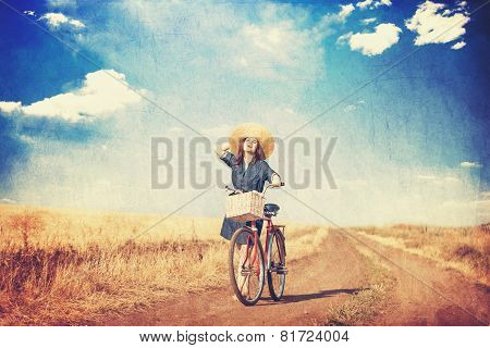 Brunette Girl  With Bycicle On Countryside Road.