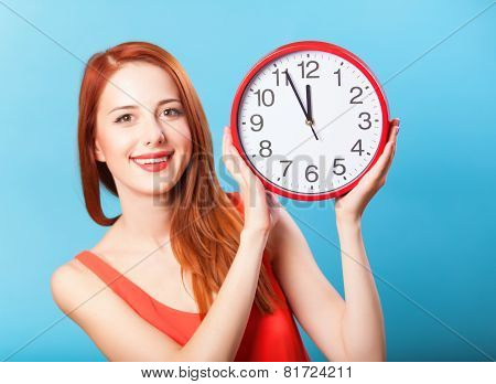 Redhead Girl With Huge Clock On Blue Background.