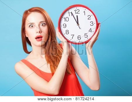 Redhead Girl With Huge Clock On Blue Background.
