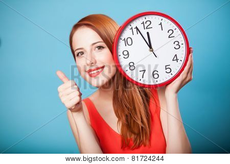 Redhead Girl With Huge Clock On Blue Background.