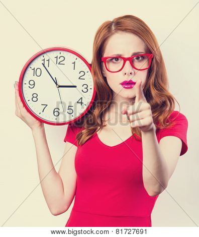 Surprised Redhead Girl With Huge Alarm Clock On Light Background.
