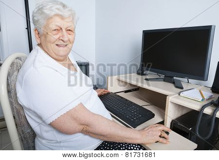 A senior person in front of his computer