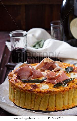 Pasta pie with cheese sauce and sage