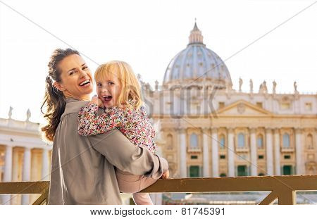 Portrait Of Happy Mother And Baby Girl In Front Of Basilica Di S
