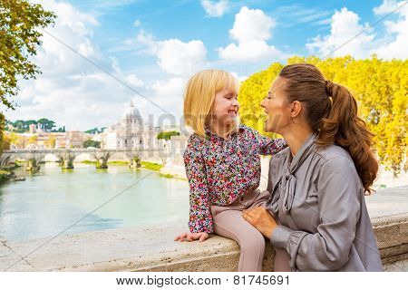 Happy Mother And Baby Girl On Bridge Ponte Umberto I With View O