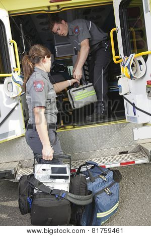 Paramedic employee with ambulance in the background.
