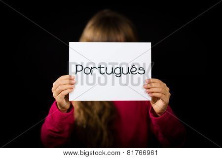 Child Holding Sign With Portuguese Word Portugues - Portuguese In English