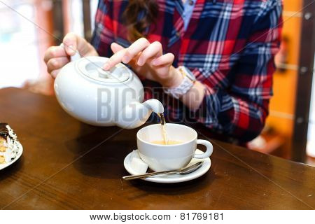 Female Hands Poured Green Tea Close Up