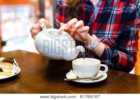 Female Hands Poured Green Tea Close-up