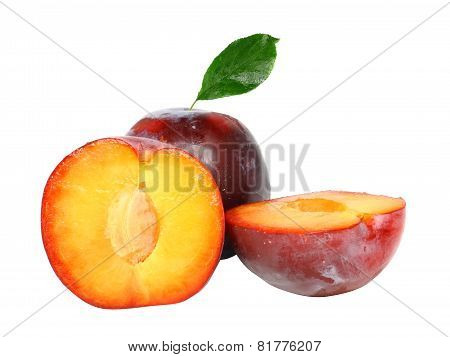 Heap Of Plums With Green Leaf. Isolated.
