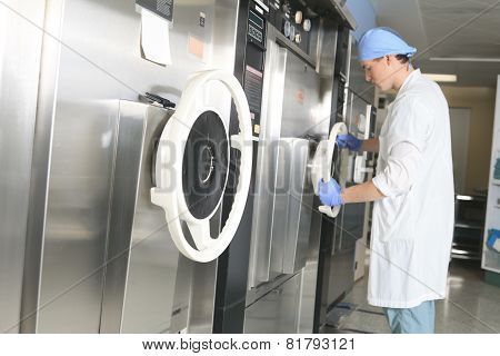 Medical staff sterilizing hands and arms before surgery