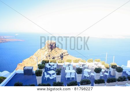 Skaros rock in Santorini against blue sea as a background