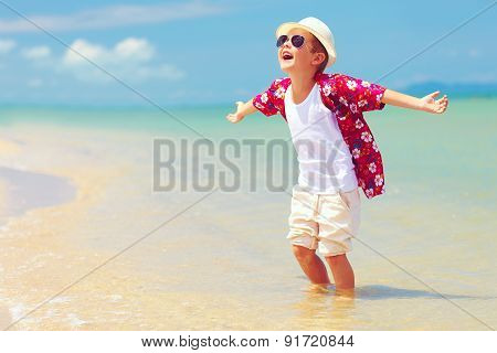 Happy Fashionable Kid Boy Enjoys Life On Summer Beach