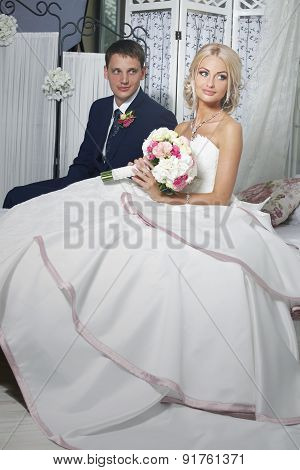 The Bride And Groom Sit