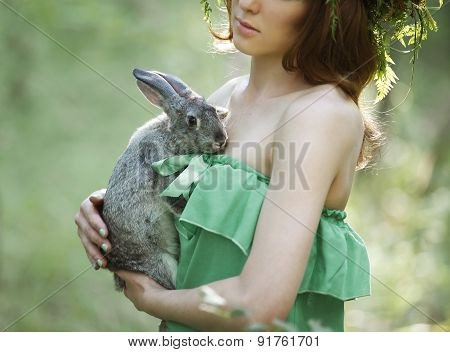 Beautiful Model With A Gray Rabbit In Her Arms