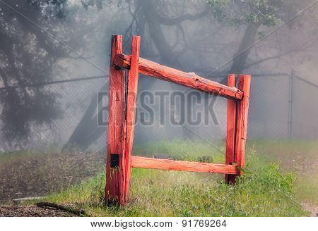 Red Stockade Fence In Forest