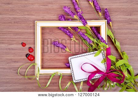 Frame of spring flowers on a wooden , with space for text , spring or summer theme