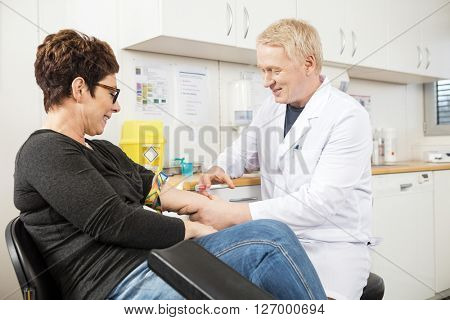 Male Doctor Collecting Patient's Blood For Test
