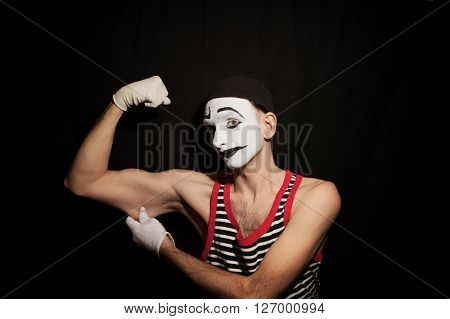 Portrait of mime actor on black background closeup
