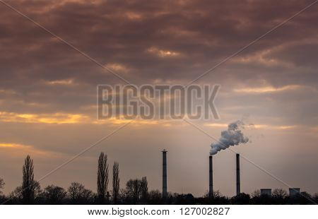 Industrial cityscape with coal power plant and smoke stacks